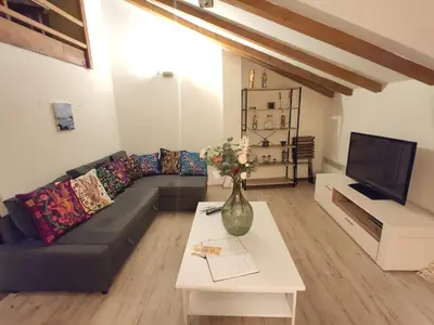 a living room with a couch and a vase on a table at CozyGem House 2