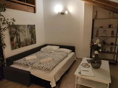 a small bedroom with a bed and a table at CozyGem House 2