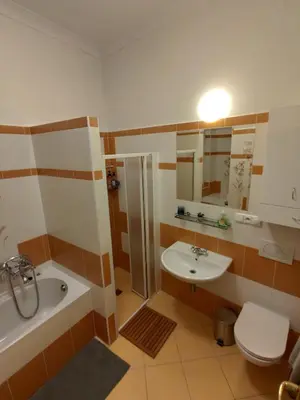 a bathroom with a sink and a tub and a toilet at CozyGem House 2
