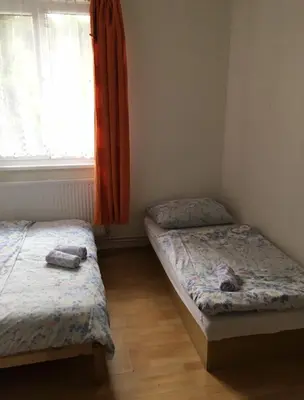 two twin beds in a room with a window at Lávka 222 Chocerady in Chocerady