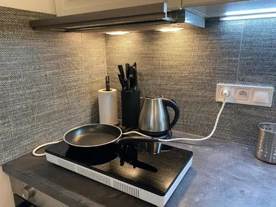 a kitchen counter with a frying pan and utensils at NEW apartment in Prague in Prague