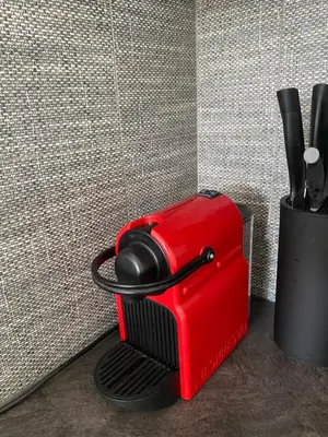 a red toaster sitting next to a wall at NEW apartment in Prague in Prague