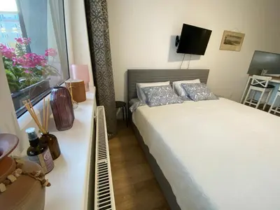 a small bedroom with a bed and a window at NEW apartment in Prague in Prague