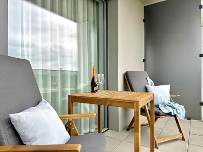 a living room with a table and a bottle of wine at REAL Living by REFA Balcony Retreat 75 in Prague