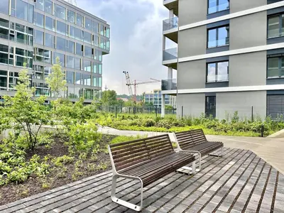 a garden with yellow flowers in front of a building at REAL Living by REFA Balcony Retreat 75 in Prague