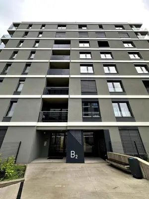 a large gray building with a sign that says bba at REAL Living by REFA Balcony Retreat 75 in Prague