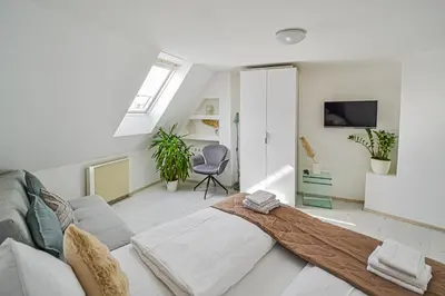 a living room with a couch and a chair at Main Square Quite Air Conditioned Apartment in Prague