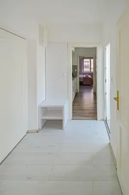 a white hallway with a white door and a white floor at Main Square Quite Air Conditioned Apartment in Prague
