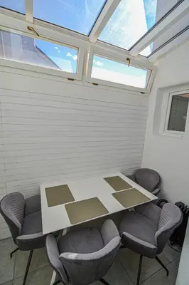a white table and chairs in a room with windows at Main Square Quite Air Conditioned Apartment in Prague
