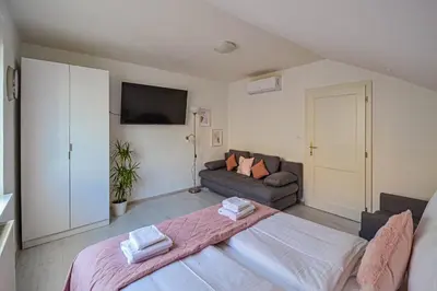 a bedroom with a large bed and a couch at Main Square Quite Air Conditioned Apartment in Prague