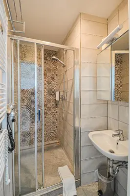 a bathroom with a shower and a sink at Main Square Quite Air Conditioned Apartment in Prague