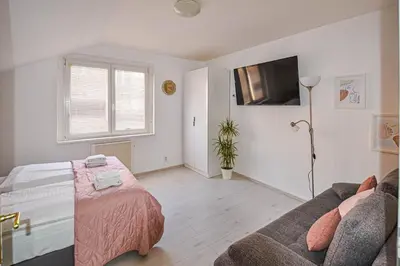 a living room with a bed and a couch at Main Square Quite Air Conditioned Apartment in Prague