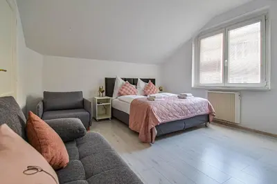 a bedroom with a bed and a couch at Main Square Quite Air Conditioned Apartment in Prague
