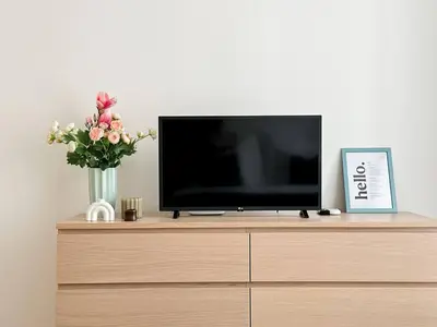 a flat screen tv sitting on top of a dresser at REAL Living by REFA Karlin 406 in Prague