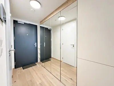 a pivot door in a room with glass partitions at REAL Living by REFA Karlin 406 in Prague