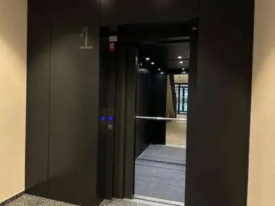 a black elevator with a glass door in a building at REAL Living by REFA Karlin 406 in Prague