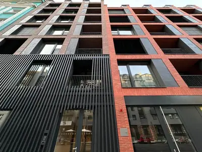 a tall building with many windows on a street at REAL Living by REFA Karlin 406 in Prague