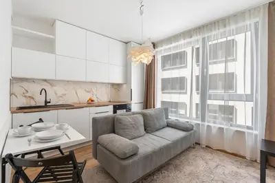 a living room with a couch and a table at REAL Living by REFA Karlin 305 in Prague