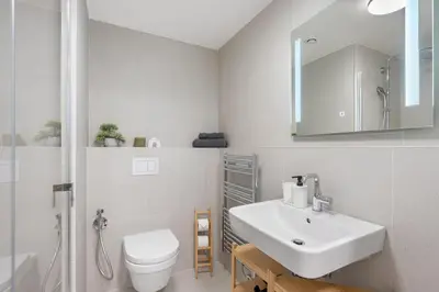 a white bathroom with a sink and a toilet at REAL Living by REFA Karlin 305 in Prague