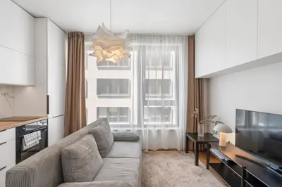 a living room with a couch and a television at REAL Living by REFA Karlin 305 in Prague