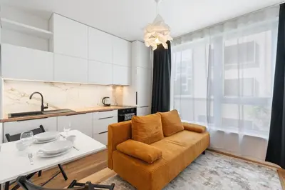 a living room with a couch and a table at REAL Living by REFA Karlin 208 in Prague