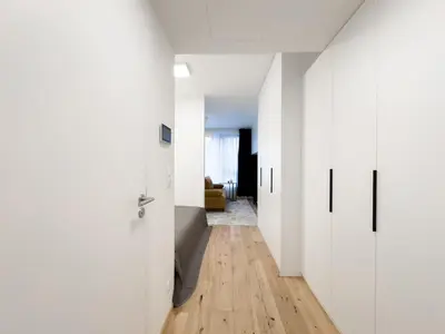a hallway with white doors and a wooden floor at REAL Living by REFA Karlin 208 in Prague