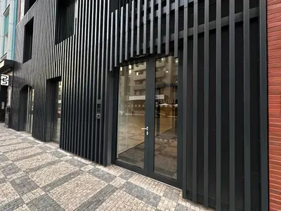 a building with glass doors on a street at REAL Living by REFA Karlin 208 in Prague