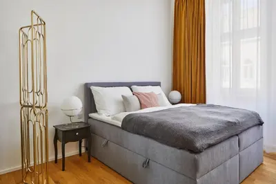 a bedroom with a large bed and a window at Modern & Elegant, 3 min of Wenceslas Square in Prague