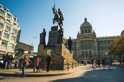 a group of people standing around a statue in front of a building at Modern & Elegant, 3 min of Wenceslas Square in Prague
