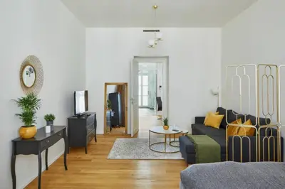 a living room with a couch and a tv at Modern & Elegant, 3 min of Wenceslas Square in Prague