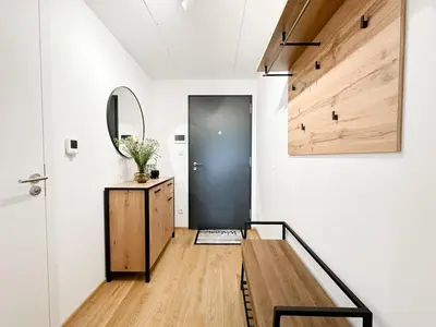 a hallway with a black door and a mirror at REAL Living by REFA Balcony Retreat 91 in Prague