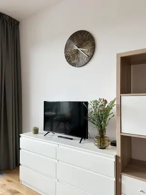a white dresser with a television on top of it at REAL Living by REFA Balcony Retreat 91 in Prague