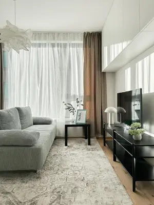 a living room with a couch and a tv at REAL Living by REFA Karlin 307 in Prague