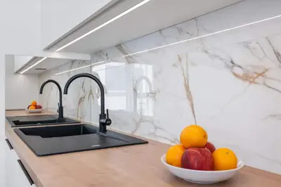 a kitchen with a bowl of fruit on a counter at REAL Living by REFA Karlin 307 in Prague
