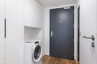 a door to a laundry room with a washing machine at REAL Living by REFA Karlin 307 in Prague