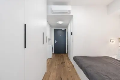 a bedroom with a bed and a black door at REAL Living by REFA Karlin 307 in Prague