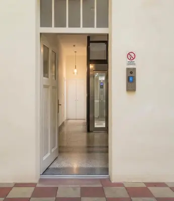 a white door with a rug on a black and white floor at Chic Flat on Jecna Walk to Wenceslas Sq and Museum in Prague