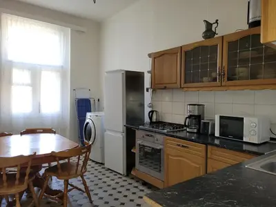 a kitchen with a table and a refrigerator and a table and chairs at Bright 2BDR sleeps 8 near center M1 in Prague