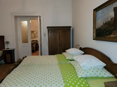 a bedroom with a bed with green and white pillows at Bright 2BDR sleeps 8 near center M1 in Prague