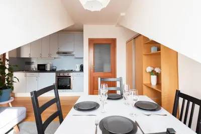 a kitchen and dining room with a table and chairs at Morya Sky Apartment in Prague
