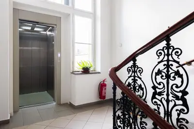 a hallway with a walk in shower and a glass door at Morya Sky Apartment in Prague