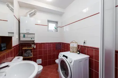 a bathroom with a washing machine and a sink at Morya Sky Apartment in Prague