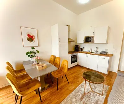 a kitchen and dining room with a table and chairs at Prague 1 Center Elegant 2BR Apartment with Panoramic Museum View and King Bed in Prague
