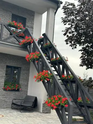 a black railing with flower boxes on a building at TAVI Apart-Hotel in Nupaky