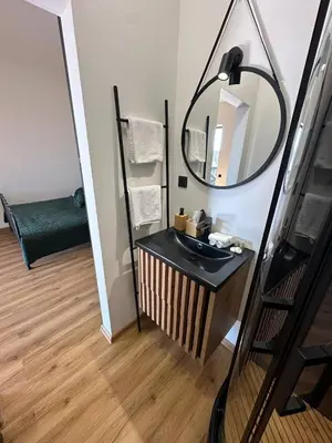 a bathroom with a sink and a mirror at TAVI Apart-Hotel in Nupaky