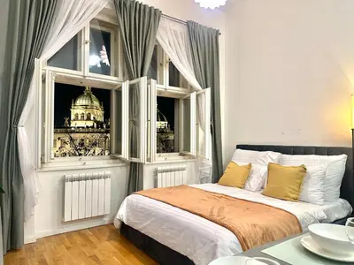 a bedroom with a large window with a building at Prague 1 Center Modern 2BR Apartment with Panoramic Museum View and King Bed in Prague