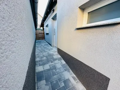 a hallway of a building with a door and a tile floor at Apartmán v klidné části Benešova in Benešov