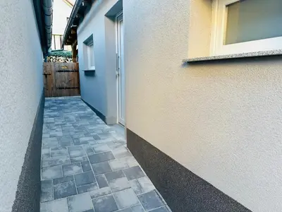 a hallway of a building with a door and a tile floor at Apartmán v klidné části Benešova in Benešov