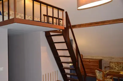 a spiral staircase in a house with a living room at Penzion Aurooms in Zlatníky
