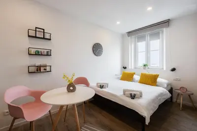 a bedroom with a bed and a table and chairs at Sunset View Apartment in Prague